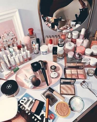 Professional makeup products and beauty essentials arranged on a makeup vanity.